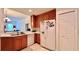Well-lit kitchen with white appliances, wood cabinets, tile flooring, and a breakfast bar at 921 Begonia Rd # 302, Celebration, FL 34747