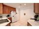 Bright kitchen featuring stainless steel sink, white appliances, tile backsplash, and white countertops at 921 Begonia Rd # 302, Celebration, FL 34747