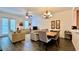 Bright living room with neutral tones, hardwood floors, ceiling fan, and dining area at 921 Begonia Rd # 302, Celebration, FL 34747