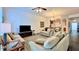 Spacious living room featuring comfortable sofas, dark wood floors, and an adjacent kitchen at 921 Begonia Rd # 302, Celebration, FL 34747