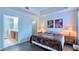 Neutral main bedroom featuring wood flooring, lamps, and ensuite bathroom with a step-in shower at 921 Begonia Rd # 302, Celebration, FL 34747