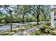 View of a quiet street lined with mature trees and sidewalks featuring a school crossing sign at 921 Begonia Rd # 302, Celebration, FL 34747
