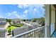 A scenic community view from a balcony overlooking rooftops and greenery under a partly cloudy sky at 921 Begonia Rd # 302, Celebration, FL 34747