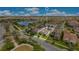 Aerial view of a home in a lakeside community with green spaces and beautiful landscaping at 9544 Mere Pkwy, Orlando, FL 32832