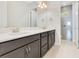 This bathroom features a double vanity, sleek countertops, and a glass enclosed shower at 9544 Mere Pkwy, Orlando, FL 32832