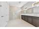 Bathroom featuring double sinks, granite countertops, and a glass-enclosed shower at 9544 Mere Pkwy, Orlando, FL 32832