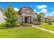 Charming home with manicured landscaping, stone accents, and a covered entryway for great curb appeal at 9544 Mere Pkwy, Orlando, FL 32832