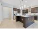 Spacious kitchen featuring a large island, stainless steel appliances, and modern finishes at 9544 Mere Pkwy, Orlando, FL 32832