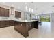 Well-appointed kitchen with a large island, stainless steel hood, and open layout to the dining area at 9544 Mere Pkwy, Orlando, FL 32832