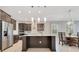Bright, open kitchen with a large island, stainless appliances, and an adjacent dining area at 9544 Mere Pkwy, Orlando, FL 32832