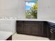 This laundry room boasts ample storage with sleek cabinets and a utility sink at 9544 Mere Pkwy, Orlando, FL 32832