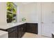 Bright laundry room with ample counter space, cabinets, and a large window at 9544 Mere Pkwy, Orlando, FL 32832