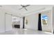 Primary bedroom featuring tile flooring, barn door to bath, ceiling fan and large windows at 9544 Mere Pkwy, Orlando, FL 32832