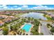 Community pool surrounded by palm trees, lounge chairs, and well-maintained landscaping at 9544 Mere Pkwy, Orlando, FL 32832