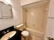 A well-lit bathroom features a combination bathtub and shower, a vanity, and a toilet at 9903 Turf Way # 4, Orlando, FL 32837