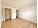 This bedroom has a closet, tile flooring, and neutral colored walls at 9903 Turf Way # 4, Orlando, FL 32837