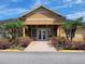 Exterior view of the community clubhouse entrance with manicured landscaping and ample parking at 9903 Turf Way # 4, Orlando, FL 32837