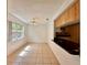 Cozy dining area featuring tile floors, ample natural light, and a pass-through view of the kitchen at 9903 Turf Way # 4, Orlando, FL 32837
