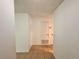 Bright hallway featuring tile flooring, neutral walls, and doorways leading to different rooms at 9903 Turf Way # 4, Orlando, FL 32837