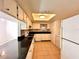 Bright kitchen featuring white cabinets, black countertops, and modern appliances at 9903 Turf Way # 4, Orlando, FL 32837