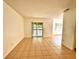 Open-concept living room featuring tile flooring, sliding glass doors, and bright natural light at 9903 Turf Way # 4, Orlando, FL 32837