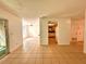 Bright living space with tile flooring, a view of the dining area, and a pass-through to the kitchen at 9903 Turf Way # 4, Orlando, FL 32837