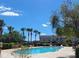 Community pool and clubhouse with clear blue skies and surrounding landscape at 9903 Turf Way # 4, Orlando, FL 32837
