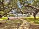 Community tennis court nestled among mature shade trees in a tranquil setting at 9903 Turf Way # 4, Orlando, FL 32837
