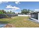 Large backyard with a screened-in patio, well-maintained lawn, and fenced perimeter for privacy at 994 Lormann Cir, Longwood, FL 32750