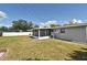 Expansive backyard featuring a screened-in patio, lush green lawn, and a charming storage shed at 994 Lormann Cir, Longwood, FL 32750