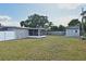The home's large backyard features a screened-in patio, lush green lawn, and a storage shed at 994 Lormann Cir, Longwood, FL 32750