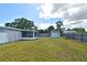 Large backyard featuring a screened-in patio, lush green lawn, and a charming storage shed at 994 Lormann Cir, Longwood, FL 32750