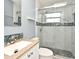 Modern bathroom featuring tiled shower with glass doors, river rock floor and vanity at 994 Lormann Cir, Longwood, FL 32750