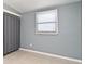 Bright bedroom featuring a window with blinds and a closet with curtain at 994 Lormann Cir, Longwood, FL 32750