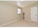 A brightly lit vacant bedroom features neutral paint and a view to the ensuite bathroom at 994 Lormann Cir, Longwood, FL 32750