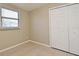 Bright bedroom featuring a window with blinds and a closet with paneled doors at 994 Lormann Cir, Longwood, FL 32750