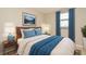 Cozy bedroom features a plush bed, side table with lamp, and mountain artwork at 994 Lormann Cir, Longwood, FL 32750
