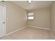 A vacant bedroom features neutral paint, tile floor, and natural light from the window at 994 Lormann Cir, Longwood, FL 32750