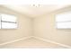 An empty bedroom featuring bright natural light with tile flooring and neutral paint at 994 Lormann Cir, Longwood, FL 32750