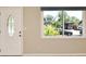 Bright entryway with a decorative door, large window, and neutral wall colors at 994 Lormann Cir, Longwood, FL 32750