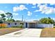 Charming single-story home featuring a well-manicured lawn, blue door, and a convenient carport at 994 Lormann Cir, Longwood, FL 32750