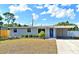 Charming single-story home featuring a well-manicured lawn, blue door, and a convenient carport at 994 Lormann Cir, Longwood, FL 32750