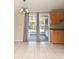Kitchen with backyard patio access and tan cabinetry above speckled countertops at 994 Lormann Cir, Longwood, FL 32750