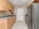 Kitchen with speckled countertops, stainless steel refrigerator and sink, and bright lighting at 994 Lormann Cir, Longwood, FL 32750