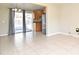 Open concept living room leading to kitchen with stainless steel refrigerator and backyard patio at 994 Lormann Cir, Longwood, FL 32750