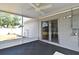 The screened-in patio offers gray flooring and easy access to backyard through sliding glass door at 994 Lormann Cir, Longwood, FL 32750