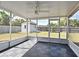 Relaxing screened-in patio, featuring gray tile flooring and backyard views of lawn and storage shed at 994 Lormann Cir, Longwood, FL 32750