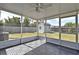 The screened-in patio offers gray flooring and a backyard view with a storage shed and green grass at 994 Lormann Cir, Longwood, FL 32750
