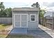 Backyard shed with double doors, window, ramp, and stone pavers at 994 Lormann Cir, Longwood, FL 32750