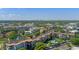 Stunning aerial view of a condo building showcasing mature landscaping and a community pool at 100 S Interlachen Ave # 410F, Winter Park, FL 32789